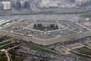 FILE - In this March 27, 2008 file photo, the Pentagon is seen in this aerial view in Washington. A Pentagon official tells The Associated Press that transgender people can enlist in the military beginning Jan. 1, despite President Donald Trump's opposition. The new policy reflects growing legal pressure on the issue. Potential transgender recruits will have to overcome a lengthy and strict set of physical, medical and mental conditions that make it possible, although difficult, for them to join the armed services. (AP Photo/Charles Dharapak, File)