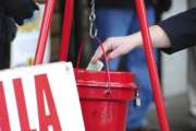 FILE - In this Nov. 22, 2017, file photo, a patron donates money in a Salvation Army red kettle in Wilkes-Barre, Pa. In this season of giving, charity seems to be getting an extra jolt because the popular tax deduction for charitable donations will lose a lot of its punch.  (Mark Moran/The Citizens' Voice via AP)