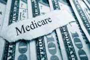 Medicare paper headline on hundred dollar bills