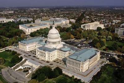 FILE - In this Oct. 24, 2001, file photo, the United States Capitol in Washington, D.C. is shown in an aerial view. The GOP-led Congress is hoping to approve a must-pass spending bill as the clock ticks toward potential government shutdown this weekend. (AP Photo/J. Scott Applewhite, File)