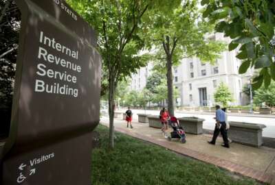 FILE - This Aug. 19, 2015, file photo, shows the Internal Revenue Service Building in Washington. The tax overhaul bill has yet to be passed at this point. But if it does, those changes will take effect in 2018. The IRS said that it is closely monitoring the bill and expects to issue initial withholding guidance in January, which would allow taxpayers to begin seeing the benefits of the change as early as February. (AP Photo/Andrew Harnik, File)