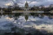 Clouds are reflected in the U.S. Capitol reflecting pool at daybreak in Washington as day three of the government shutdown continues, Monday, Jan. 22, 2018. (AP Photo/J. David Ake)