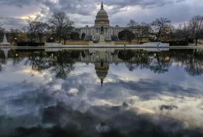 Clouds are reflected in the U.S. Capitol reflecting pool at daybreak in Washington as day three of the government shutdown continues, Monday, Jan. 22, 2018. (AP Photo/J. David Ake)