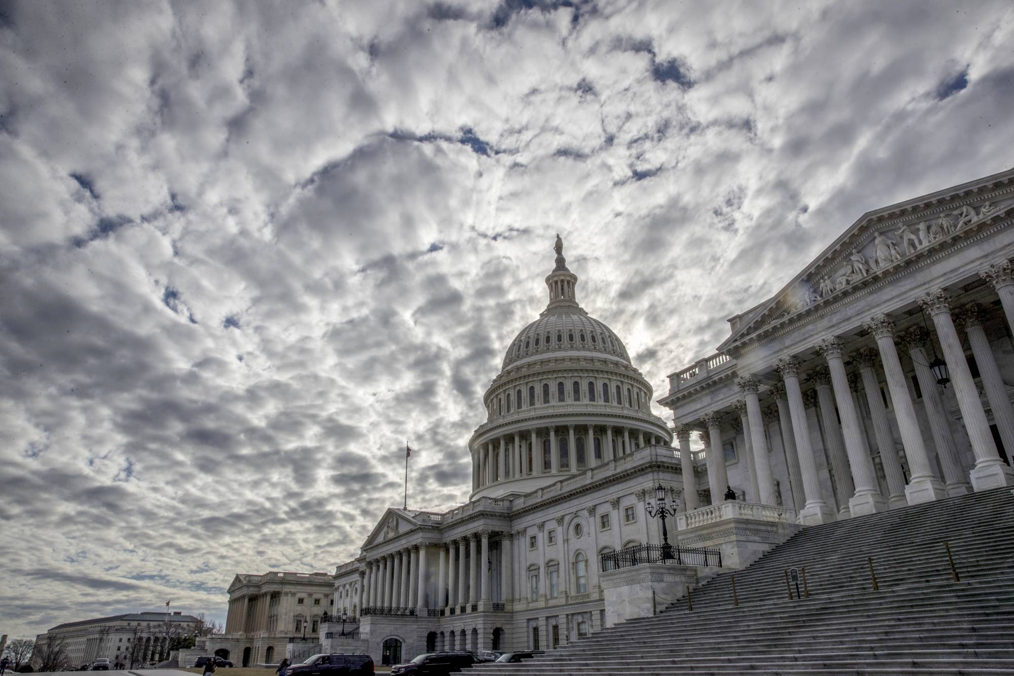 The Capitol is seen under cloudy skies on Day 2 of the federal shutdown, in Washington, Sunday, Jan. 21, 2018. (AP Photo/J. Scott Applewhite)