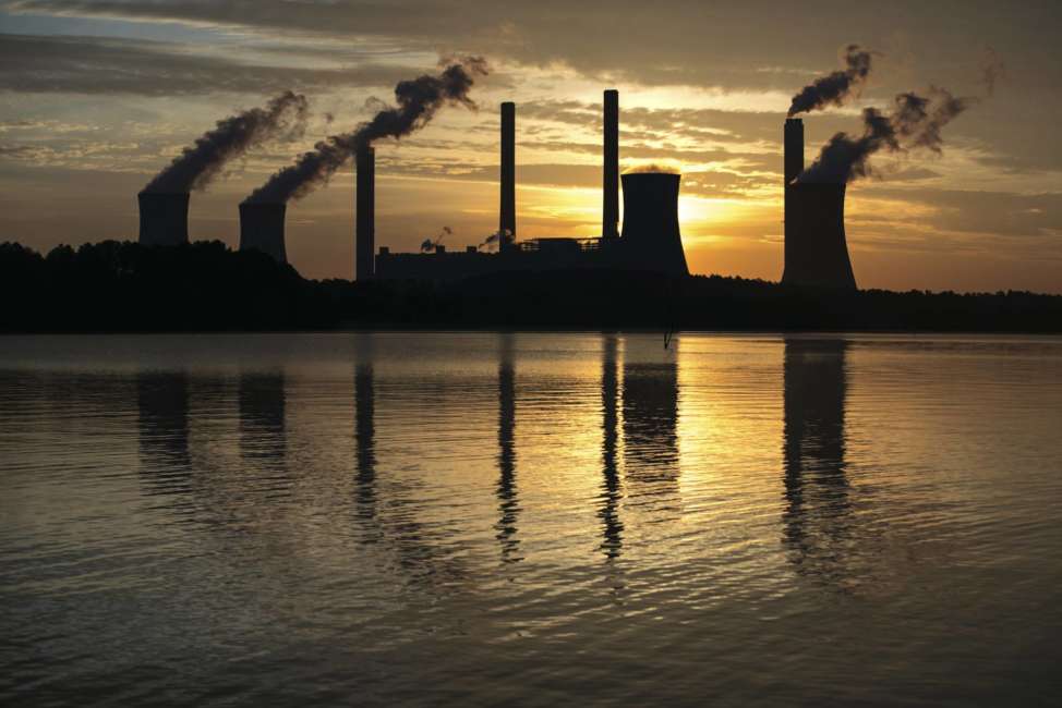 FILE - In this June 3, 2017, file photo, the coal-fired Plant Scherer in Juliette, Ga. The Trump administration is doing away with a decades-old air emissions policy opposed by fossil fuel companies, a move that environmental groups say will result in more pollution. The Environmental Protection Agency issued notice Thursday it is withdrawing the “once-in always-in” policy under the Clean Air Act, which dictated how major sources of hazardous air pollutants are regulated. (AP Photo/Branden Camp, File)