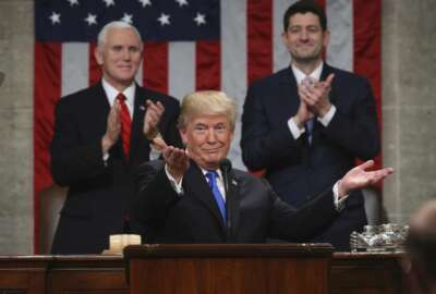 President Donald Trump gestures as delivers his first State of the Union address in the House chamber of the U.S. Capitol to a joint session of Congress Tuesday, Jan. 30, 2018 in Washington, as Vice President Mike Pence and House Speaker Paul Ryan applaud. (Win McNamee/Pool via AP)