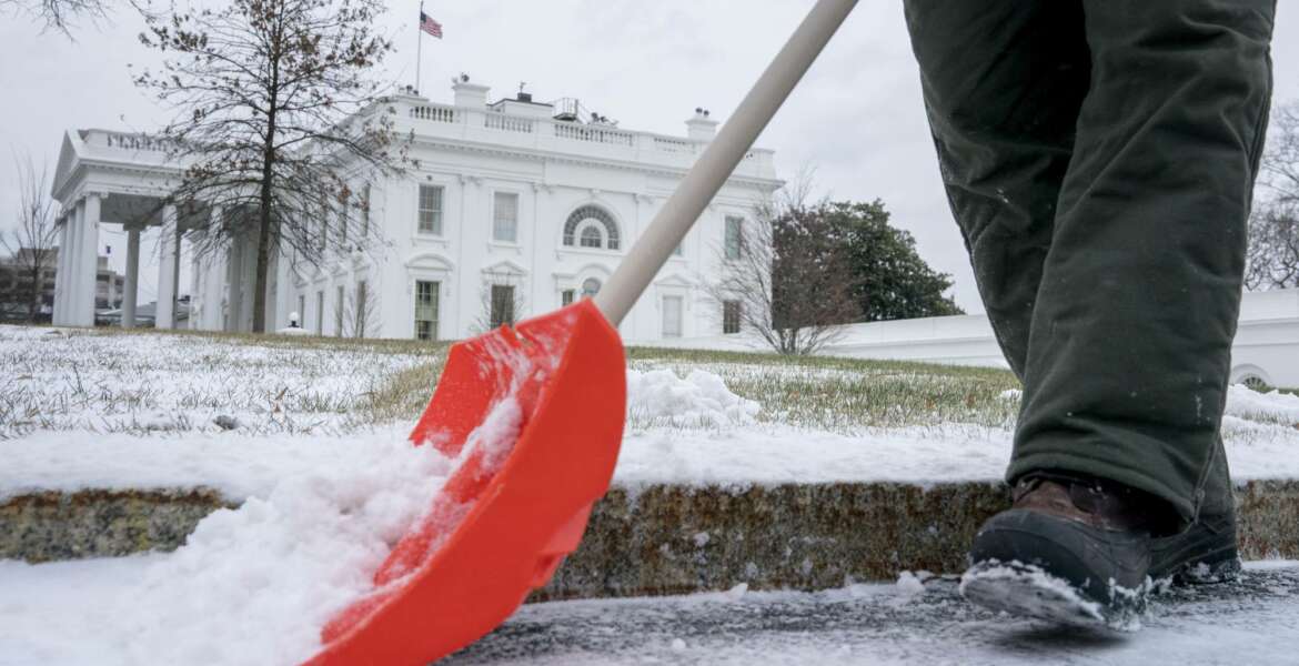 A National Park Service worker clears snow on the North side of the White House, Thursday, Jan. 4, 2018, in Washington. Residents across a huge swath of the U.S. have awakened to the beginnings of a massive winter storm expected to deliver snow, ice and high winds followed by possible record-breaking cold as it moves up the Eastern Seaboard from the Carolinas to Maine. (AP Photo/Andrew Harnik)