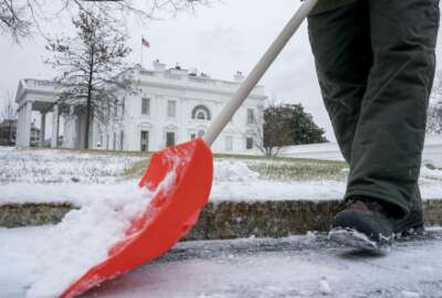 A National Park Service worker clears snow on the North side of the White House, Thursday, Jan. 4, 2018, in Washington. Residents across a huge swath of the U.S. have awakened to the beginnings of a massive winter storm expected to deliver snow, ice and high winds followed by possible record-breaking cold as it moves up the Eastern Seaboard from the Carolinas to Maine. (AP Photo/Andrew Harnik)