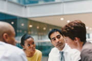 Business People Sitting in an Office Building Having a Meeting