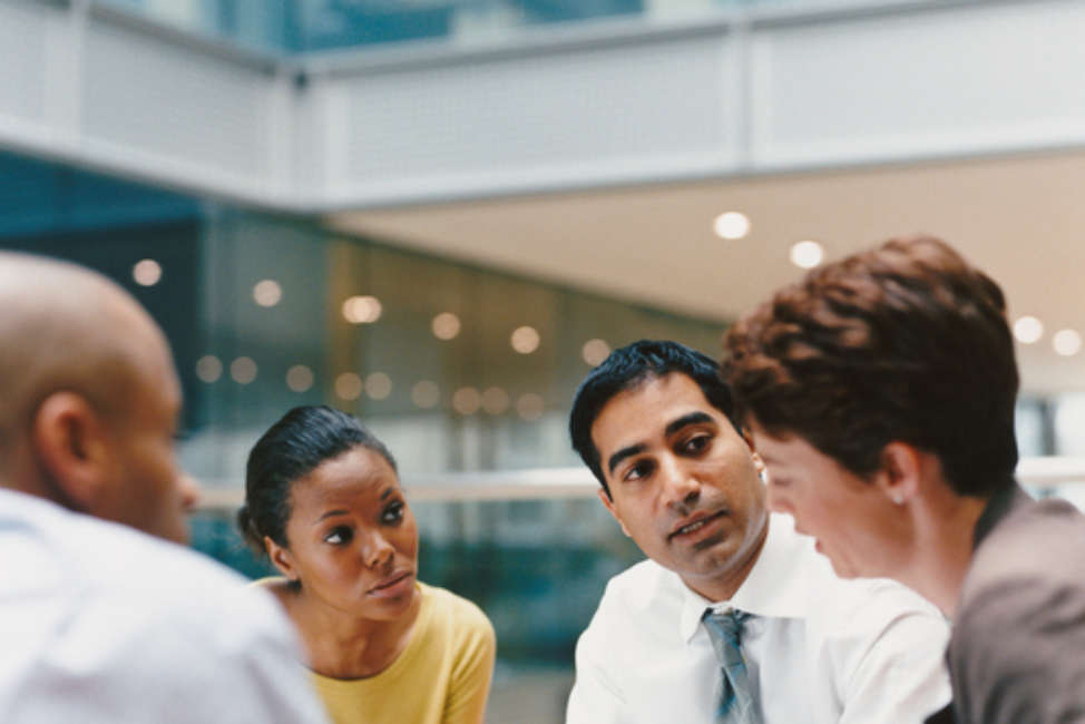 Business People Sitting in an Office Building Having a Meeting