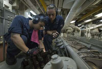 PACIFIC OCEAN (June 29, 2013) Engineman 2nd Class Jeffrey Le, left, and Fireman Elizabeth Lafferty conduct maintenance aboard the amphibious dock landing ship USS Pearl Harbor (LSD 52). Pearl Harbor, underway for Pacific Partnership 2013, is en route to the Republic of the Marshall Islands. 