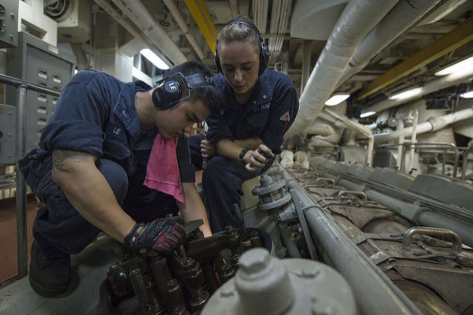 PACIFIC OCEAN (June 29, 2013) Engineman 2nd Class Jeffrey Le, left, and Fireman Elizabeth Lafferty conduct maintenance aboard the amphibious dock landing ship USS Pearl Harbor (LSD 52). Pearl Harbor, underway for Pacific Partnership 2013, is en route to the Republic of the Marshall Islands. 