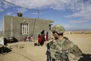 In this Jan. 27, 2018, photo, U.S. Army soldiers speak to families in rural Anbar on a reconnaissance patrol near a coalition outpost in western Iraq. A few hundred American troops are stationed at a small outpost near the town of Qaim along Iraq's border with Syria. Thousands of U.S. troops and billions of dollars spent by Washington helped bring down the Islamic State group in Iraq, but many of the divisions and problems that helped fuel the extremists’ rise remain. (AP Photo/Susannah George)