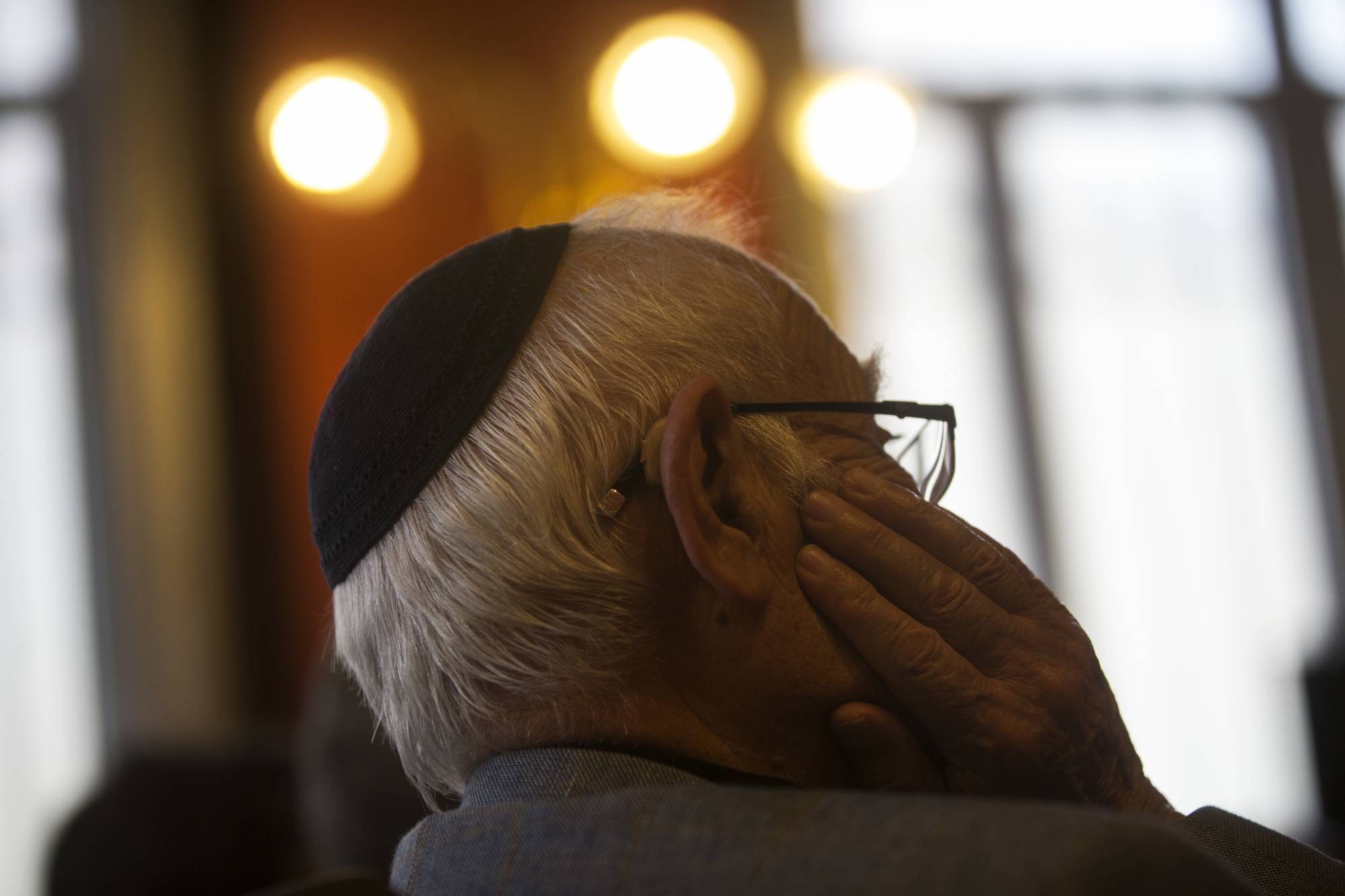 A man wearing a Jewish yarmulke listens during a news conference at the Royal Spanish Academy in Madrid, Tuesday, Feb. 20, 2018. More than five centuries after their ancestors were kicked out of Spain, Sephardic Jews are closer to being granted an academic body to oversee and protect the Ladino or Judeo-Spanish, a language with the sounds of a medieval Spanish that has been passed on almost intact for generations. (AP Photo/Francisco Seco)