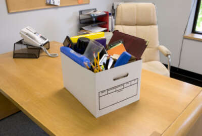 Box of office supplies on desk
