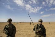 In this Saturday, Jan. 27, 2018, photo, U.S. Army soldiers conduct a reconnaissance patrol in a rural village near a coalition outpost in western Iraq. After Islamic State group fighters were pushed out of this area late last year, civilians have slowly returned to the town of Qaim and its rural outskirts near the border with Syria. Thousands of U.S. troops and billions of dollars spent by Washington helped bring down the Islamic State group in Iraq, but many of the divisions and problems that helped fuel the extremists’ rise remain. (AP Photo/Susannah George)