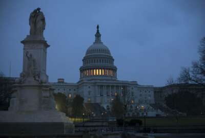 The Capitol is seen early Tuesday, March 20, 2018 in Washington.  Two major issues, the border wall and a tunnel and rail project, are holding up the massive government-wide spending bill that must pass Congress before a midnight Friday deadline to avoid another government shutdown.  An agreement could be announced as early as today.  (AP Photo/J. Scott Applewhite)