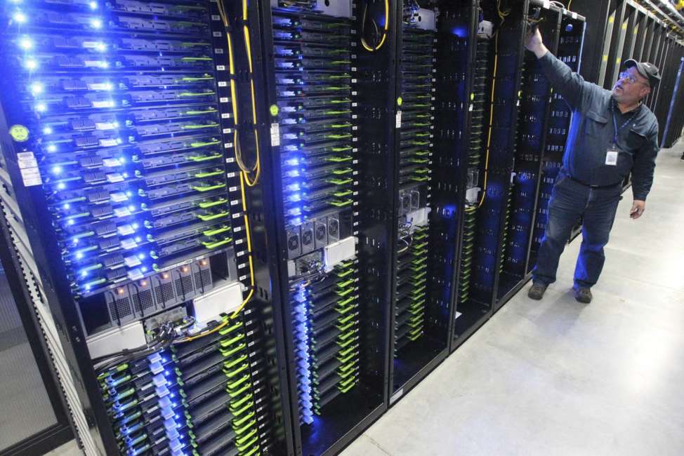 FILE - In this Oct. 15, 2013, file photo, Chuck Goolsbee, site director for Facebook's Prineville data centers, shows the computer servers that store users' photos and other data, at the Facebook site in Prineville, Ore. Facebook frequently defends its data collection and sharing activities by noting that it's adhering to a privacy policy it shares with users. (Andy Tullis/The Bulletin via AP, File)