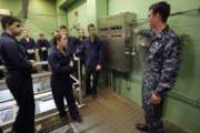 In this April 26, 2017 photo U.S. Navy Petty Officer First Class Clinton Benson, of Stanton, Mich., right, speaks to a class, including U.S. Navy Ensign Megan Stevenson, of Raymond, Maine, center left, at the Naval Submarine School, in Groton, Conn. The Navy began bringing female officers on board submarines in 2010, followed by enlisted female sailors five years later. Their retention rates are on par with those of men, according to records obtained by The Associated Press. (AP Photo/Steven Senne)