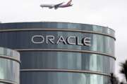 FILE - In this March 20, 2012, file photo, a plane flies over Oracle headquarters in Redwood City, Calif. On Tuesday, March 27, 2018, a federal appeals court overturned a decision in a long-running legal battle over whether Google infringed on Oracle's Java programming language to build its hugely popular mobile operating system, Android. (AP Photo/Paul Sakuma, File)