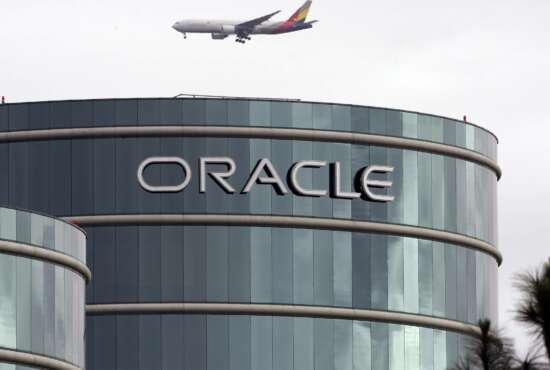 FILE - In this March 20, 2012, file photo, a plane flies over Oracle headquarters in Redwood City, Calif. On Tuesday, March 27, 2018, a federal appeals court overturned a decision in a long-running legal battle over whether Google infringed on Oracle's Java programming language to build its hugely popular mobile operating system, Android. (AP Photo/Paul Sakuma, File)
