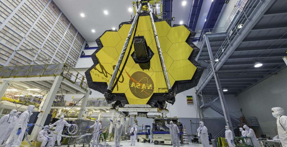 In this April 13, 2017 photo provided by NASA, technicians lift the mirror of the James Webb Space Telescope using a crane at the Goddard Space Flight Center in Greenbelt, Md. The telescope’s 18-segmented gold mirror is specially designed to capture infrared light from the first galaxies that formed in the early universe. On Tuesday, March 27, 2018, NASA announced it has delayed the launch of the next-generation space telescope until 2020. (Laura Betz/NASA via AP)