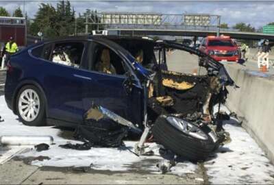 In this Friday March 23, 2018 photo provided by KTVU, emergency personnel work a the scene where a Tesla electric SUV crashed into a barrier on U.S. Highway 101 in Mountain View, Calif. The National Transportation Safety Board has sent two investigators to look into a fatal crash and fire Friday in California that involved a Tesla electric SUV. The agency says on Twitter that it's not clear whether the Tesla Model X was operating on its semi-autonomous control system called Autopilot at the time. Investigators will study the fire that broke out after the crash. (KTVU via AP)