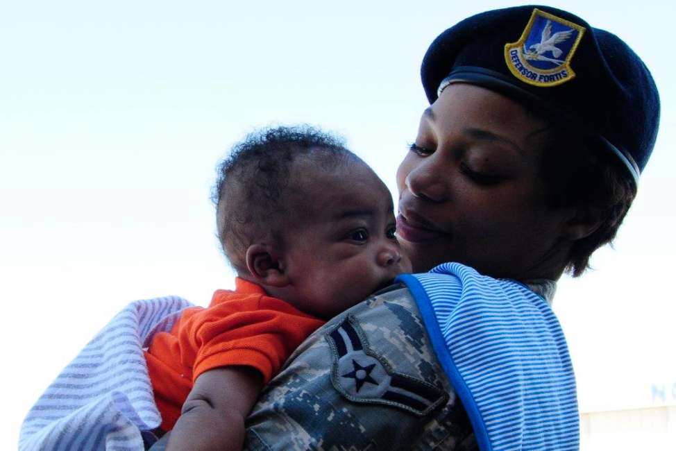 Airman 1st Class Erica Thompson, of the 145th Security Forces Squadron, holds her son, Napoleon, during a family day event at Charlotte Douglas International Airport, N.C., Oct. 1, 2016. Family day gave North Carolina Air National Guard Airmen the opportunity to show their families what happens during a regularly scheduled drill weekend. (U.S. Air National Guard photo/Staff. Sgt. Julianne M. Showalter)
