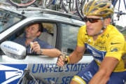 Overall leader and five-time Tour de France winner lance Armstrong, of Austin, Texas, right, holds a glass of champagne to toast with US Postal Service Sports Director Johan Bruyneel of Belgium, left, outside Fontenailles, southeast of Paris, during the 20th and last stage of the Tour de France cycling race between Montereau, southeast of Paris, and the Champs-Elysees avenue in Paris, Sunday, July 25, 2004. Lance Armstrong has just one more line to cross Sunday before seizing his place in sporting history as the first six-time winner of the celebrated Tour de France. (AP Photo/Peter Dejong)