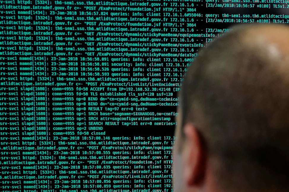 FILE - In this Jan.23 2018 file photo, a French solider watches code lines on his computer at the French Defense ministry stand during the International Cybersecurity forum in Lille, northern France. Police in Europe and North America have seized servers and data from Islamic State propaganda outlets in a multi-country operation aimed at tracking down radicals and crimping the group's ability to spread its violent message. (AP Photo/Michel Spingler, File)