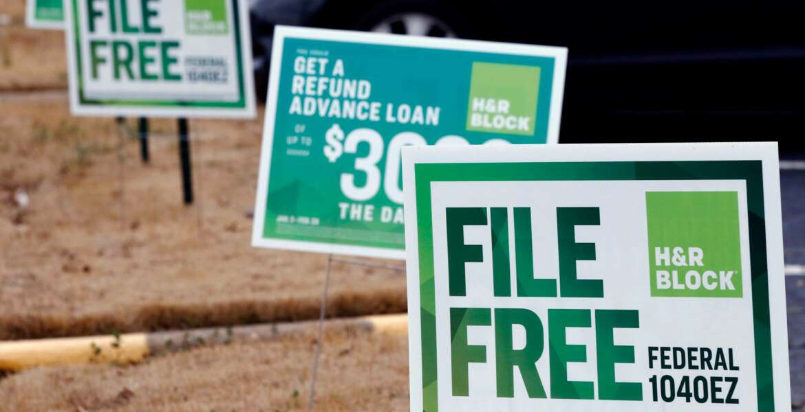 FILE- In this Feb. 14, 2018, file photo, H&R Block signs are displayed in Jackson, Miss. The tax deadline does typically fall on April 15 but that’s a Sunday this year and Monday is Emancipation Day, a Washington D.C. holiday. That means that taxpayers nationwide get a little breathing room and have until Tuesday, April 17, to get the job done. (AP Photo/Rogelio V. Solis, File)
