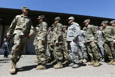 Arizona National Guard soldiers line up as they get ready for a visit from Arizona Gov. Doug Ducey prior their deployment to the Mexico border at the Papago Park Military Reservation Monday, April 9, 2018, in Phoenix. (AP Photo/Ross D. Franklin)