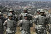 FILE--In this Aug. 18, 2010, file photo, California National Guard troops, part of Task Force Sierra, which are training for future deployment at the border along with Border Patrol Agents, stand in formation near the California/Mexico border in San Diego. California National Guard troops have started training with the U.S. Customs and Border Patrol to be camera operators, radio dispatchers, intelligence analysts and fill other support roles to free up more agents to patrol the Mexican border. (John Gibbons/San Diego Union-Tribune via AP, file)