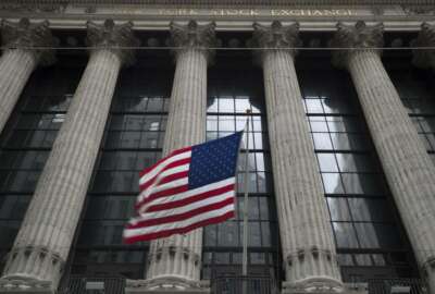 FILE- In this April 24, 2018, file photo, an American flag flies outside the New York Stock Exchange. Stocks are off to a mostly lower start on Wall Street on Thursday, May 31, as losses for banks and consumer products makers offset gains for technology companies. (AP Photo/Mary Altaffer, File)
