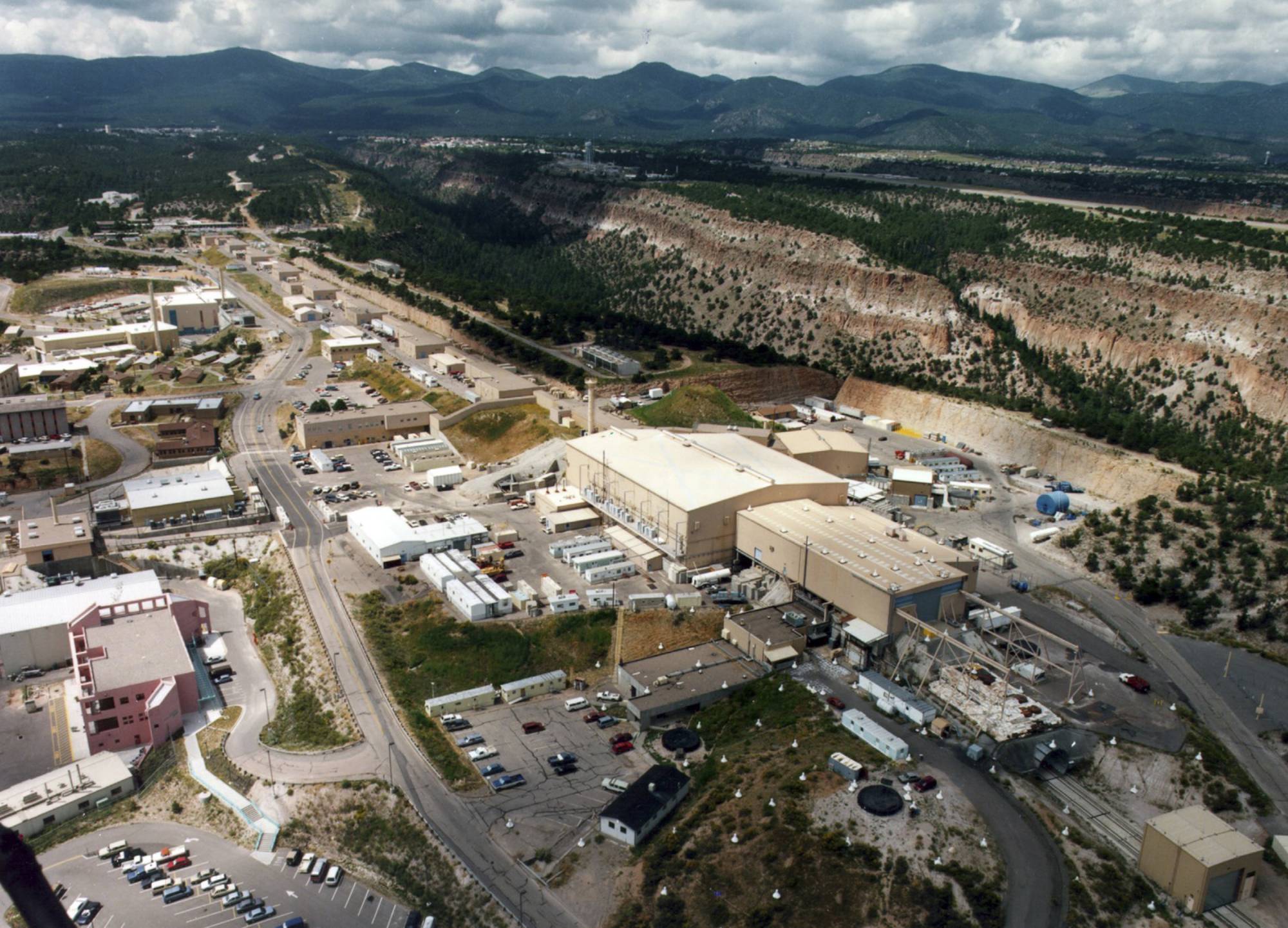 This undated aerial photo shows the Los Alamos National laboratory in Los Alamos, N.M. The federal agency that oversees the nation's nuclear weapons stockpile is expected this week to release a report on the best site option for the United States as it looks to ramp up production of the plutonium cores that trigger nuclear warheads. The contenders are the Los Alamos National Laboratory in New Mexico and the Savannah River Site in South Carolina. At stake are hundreds of jobs and billions of dollars in federal funding to either revamp existing buildings or construct new factories. (The Albuquerque Journal via AP)