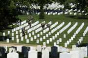 Members of the Army 3d U.S. Infantry Regiment, The Old Guard, place flags at the headstone of fallen military members during its annual Flags In ceremony at Arlington National Cemetery, May 24, 2018, in Arlington, Va. (AP Photo/Cliff Owen)