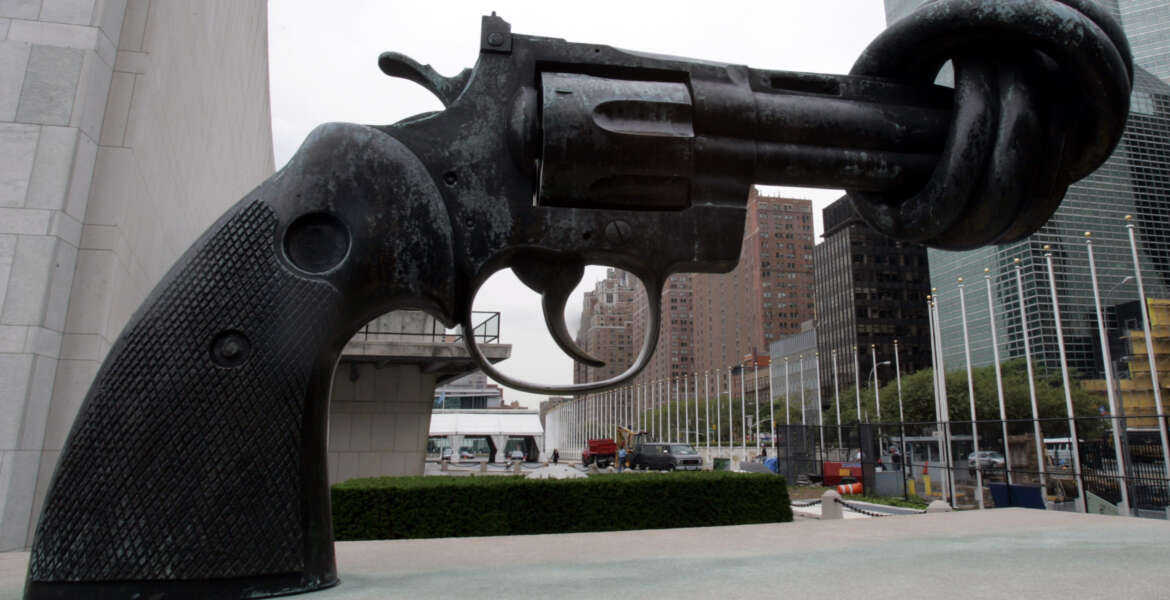 The sculpture of a hand gun with a knotted barrel is seen in front of the United Nations building in New York, Tuesday, Aug. 16, 2005. (AP Photo/Frank Franklin II)
