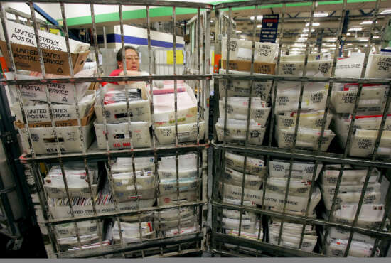 Mail handler Rolanda Ramos sorts through mail at the United States Postal Service Processing and Distribution Center in San Francisco, Wednesday, Dec. 21, 2005. Today is the busiest delivery day of the year for the postal service, according to Jim Larkin of the USPS, who estimates approximately 15 million pieces of mail being shipped. (AP Photo/Jeff Chiu)