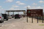 FILE - In this Sept. 9, 2014, file photo, cars wait to enter Fort Bliss in El Paso, Texas. The U.S. Department of Homeland Security has formally requested space for up to 12,000 beds at a military base to detain families caught crossing the border illegally, two Trump administration officials said Wednesday, June 27, 2018. The facility will be housed at a military base, but it's not clear yet which one. Defense Secretary Jim Mattis said that two bases had been identified to house migrants: Goodfellow Air Force Base near San Angelo, Texas, and Fort Bliss.  (AP Photo/Juan Carlos Llorca, File)