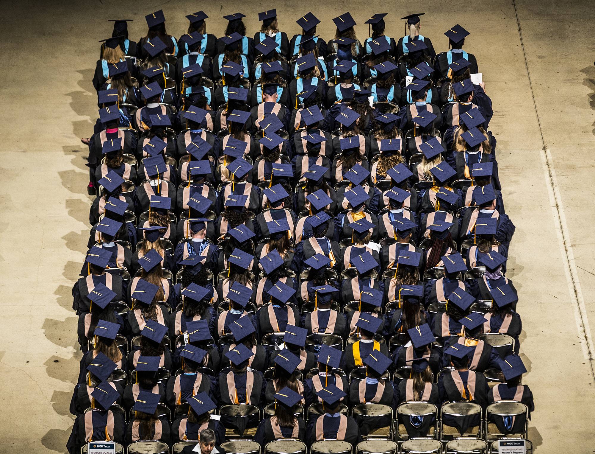 FILE- In this Sept. 30, 2017, file photo, people attend the WGU Texas annual commencement ceremony at the Frank Erwin Center in Austin, Texas. The public service loan forgiveness program was created to encourage people to take jobs to help the greater good without financially crippling themselves. These positions often require higher education but pay modest wages, such as teaching, social work, public health or law enforcement. (Ricardo B. Brazziell/Austin American-Statesman via AP, File)