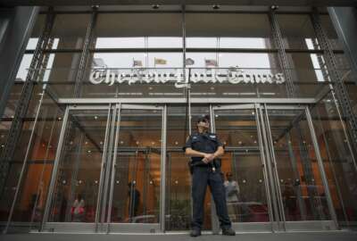 A police officer stands guard outside The New York Times building, Thursday, June 28, 2018, in New York. The New York Police Department has sent patrols to major news media organizations in response to a fatal shooting at a newspaper in Annapolis, Md. (AP Photo/Mary Altaffer)