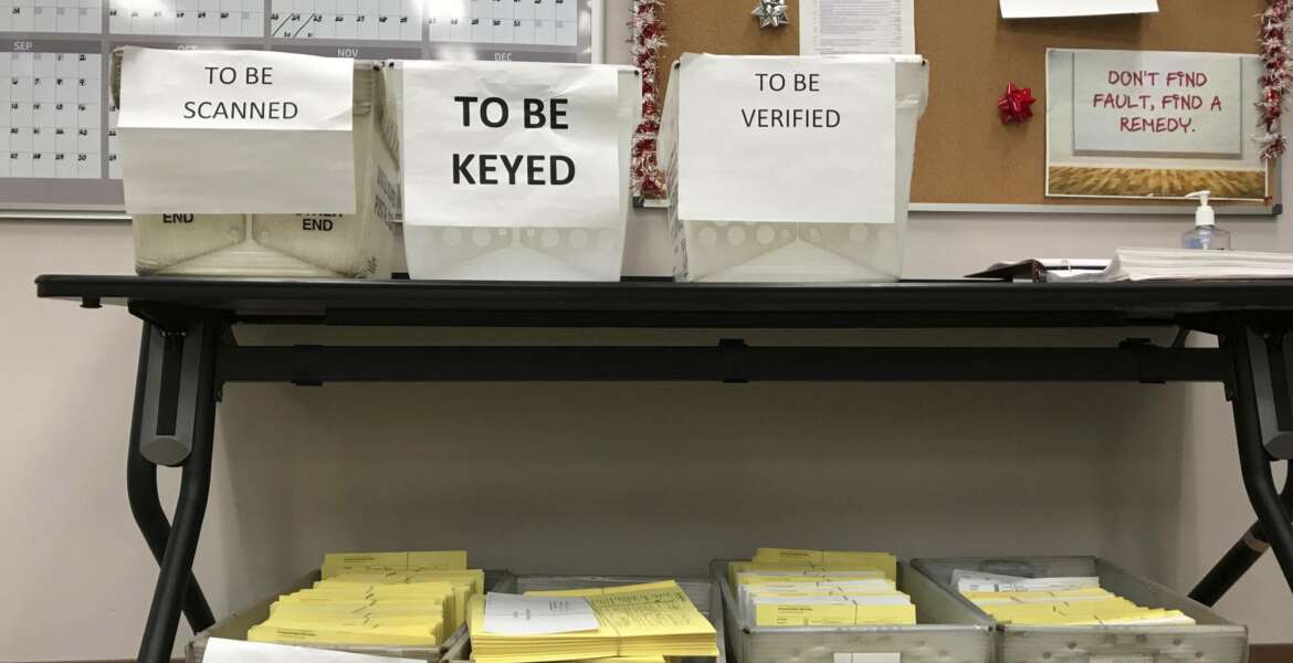 FILE - In this Dec. 14, 2017, file photo, ballots await further processing at the Franklin County Board of Elections in Columbus, Ohio. The Supreme Court is allowing Ohio to clean up its voting rolls by targeting people who haven't cast ballots in a while. The justices are rejecting, by a 5-4 vote on June 11, 2018, arguments that the practice violates a federal law that was intended to increase the ranks of registered voters. (AP Photo/Julie Carr Smyth, File)