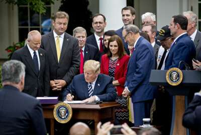 U.S. President Donald Trump signs S. 2372, the VA Mission Act of 2018, during a ceremony in the Rose Garden of the White House in Washington, D.C., U.S., on Wednesday, June 6, 2018. The bill is targeted at expanding veterans access to private-sector health care. Photographer: Andrew Harrer/Bloomberg via Getty Images