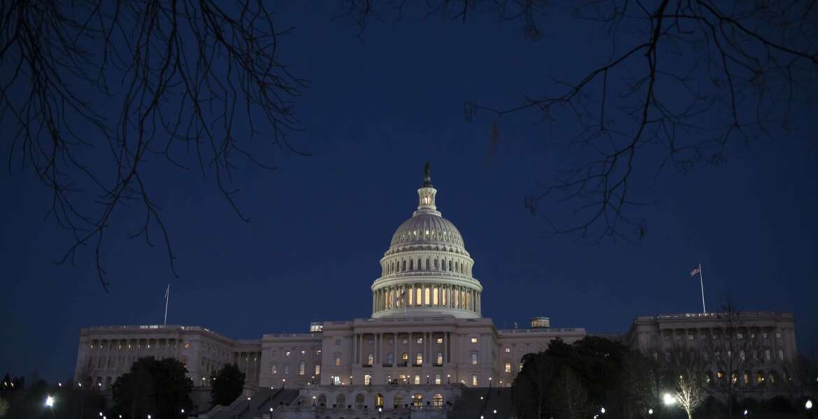 FILE - In this Jan. 19, 2018, file photo, the Capitol is illuminated in Washington. Lawmakers are honing their messaging for the midterm elections as their summer recess looms. (AP Photo/J. Scott Applewhite, File)