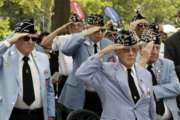 Korean War Veterans salute as the honor guard presents the American flag at the Korean War memorial at Battery Park in New York, Friday, July 27, 2018. Korean War veterans have something extra to celebrate as they mark the 65th anniversary of the armistice that ended combat. (AP Photo/Stephen Groves)