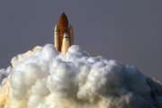 FILE - In this Aug. 8, 2007 file photo by Associated Press photojournalist Alan Diaz, the space shuttle Endeavour lifts off from the Kennedy Space Center in Cape Canaveral, Fla. Diaz, whose photo of the terrified 6-year-old Cuban boy named Elian Gonzalez earned him the Pulitzer Prize, died Tuesday, July 3, 2018, his daughter Aillette Rodriguez-Diaz said. He was 71. (AP Photo/Alan Diaz)