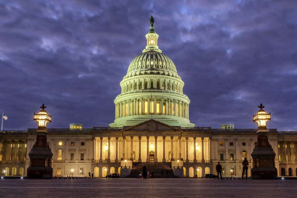 FILE - In this Jan. 21, 2018 file photo, lights shine inside the U.S. Capitol Building as night falls in Washington. Dozens of web addresses implying U.S. senators were “for sale” have been quietly and mysteriously purchased online, amid heightened concerns on Capitol Hill that foreign agents _ especially Russians _ might be trying to interfere in the upcoming midterm elections. The Associated Press has determined that Democrats were responsible. The cybersecurity director for the sergeant-at-arms in the Senate has begun to look into the matter.   (AP Photo/J. David Ake)