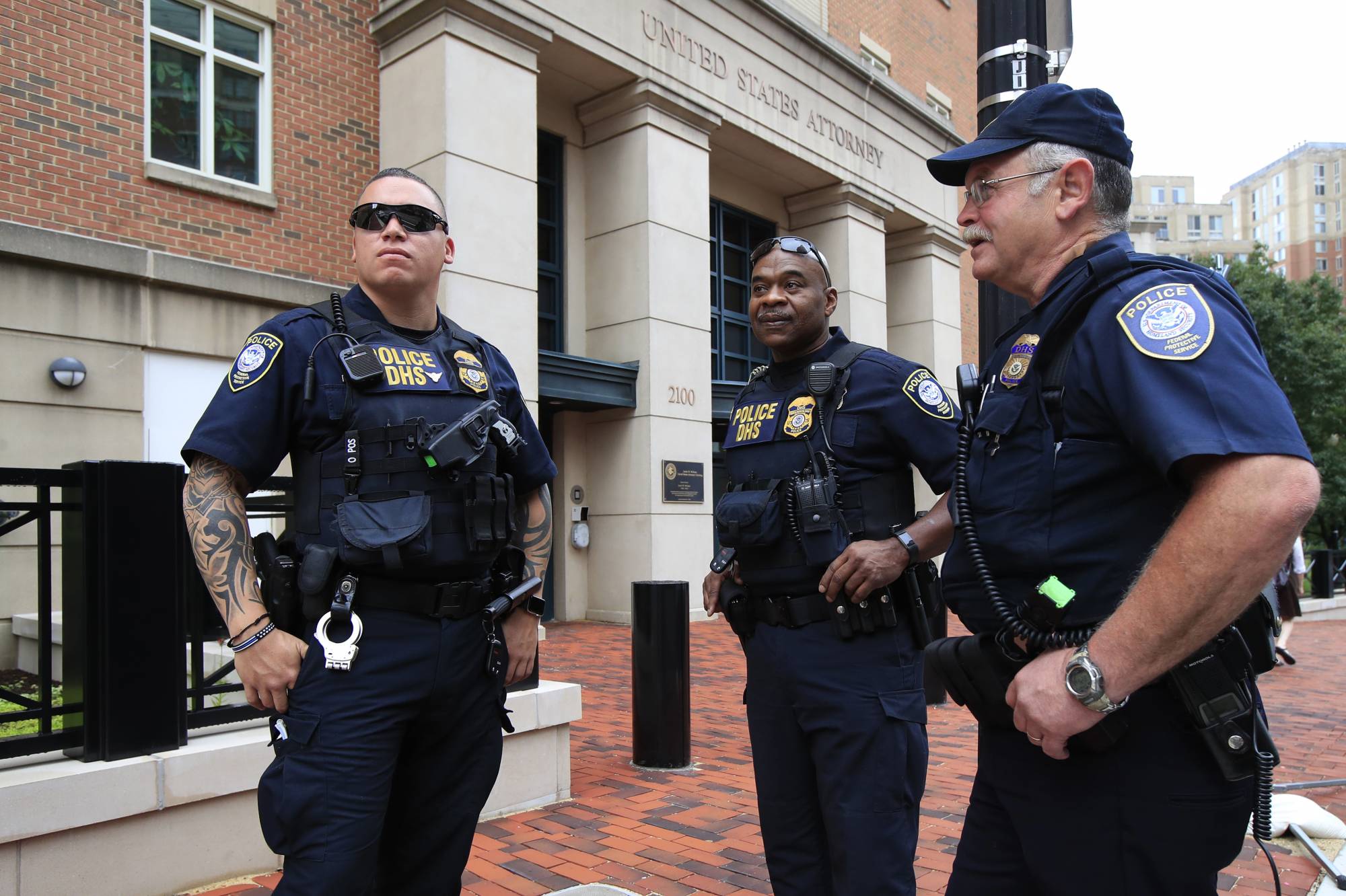 Security personnel from the Department of Homeland Security's Federal Protective Service, watch the vicinity around the Alexandria Federal Court in Alexandria, Va., on day one of Paul Manafort's trial, Tuesday, July 31, 2018. (AP Photo/Manuel Balce Ceneta)