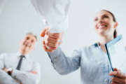 Confident business people shaking hands and woman smiling, recruitment and agreement concept