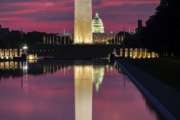 The U.S. Capitol and the base of the Washington Monument are mirrored in the reflecting pool on the National Mall at sunrise in Washington, Saturday, Aug. 25, 2018. (AP Photo/J. David Ake)